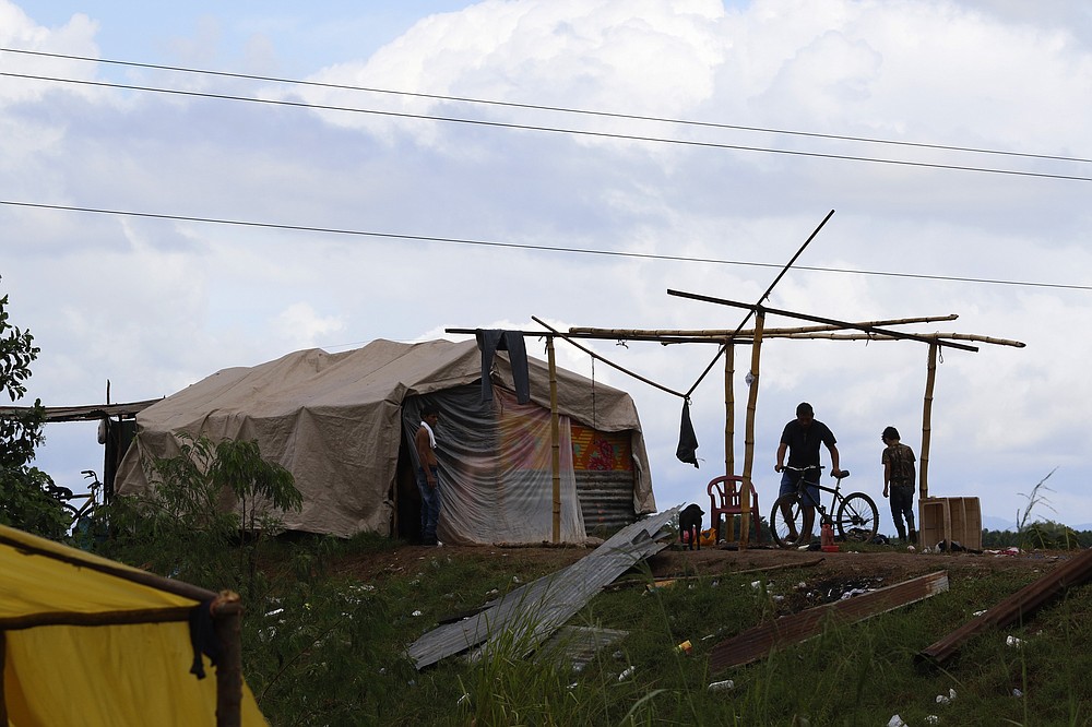 People living under precarious conditions make preparations before Hurricane Iota makes landfall in San Manuel Cortes, Honduras, Monday, November 16, 2020. Hurricane Iota rapidly strengthened into a Category 5 storm that is likely to bring catastrophic damage to the same part of Central America already battered by a powerful Hurricane Eta less than two weeks ago. (AP Photo/Delmer Martinez)