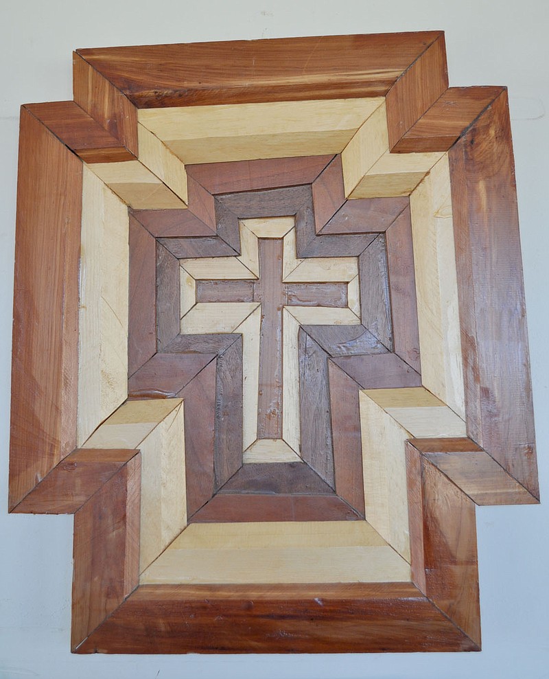 RACHEL DICKERSON/MCDONALD COUNTY PRESS Kennith Gideon's favorite piece of woodwork is shown. It is a reversible cross made in various layers of wood.