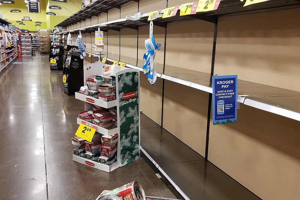 Shelves in the toilet paper aisle at a Fred Meyer store sit empty in Happy Valley, Ore., Saturday, Nov. 14, 2020, the day after Gov. Kate Brown announced new restrictions on businesses that included capacity limits in grocery stores. A surge of new coronavirus cases in the U.S. is sending people back to stores to stockpile again, leaving shelves bare and forcing retailers to put limits on purchases. (Samantha Swindler/The Oregonian via AP)