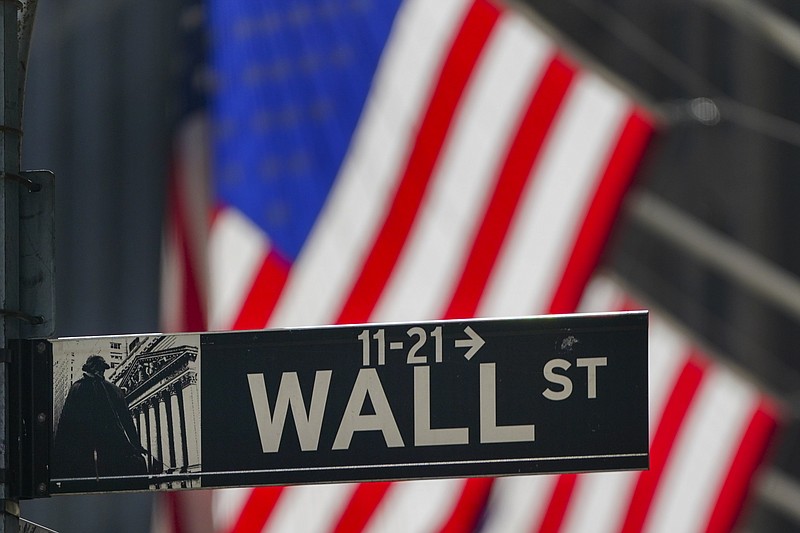 FILE - In this Oct. 14, 2020 file photo, the American Flag hangs outside the New York Stock Exchange in New York. U.S. stocks are drifting close to their record highs Wednesday, Nov. 18 as hopes for a coronavirus vaccine coming in the future collide with worries about the worsening pandemic in the present.  The S&P 500 was 0.1% lower in early trading after flipping between small gains and losses.  (AP Photo/Frank Franklin II, File)