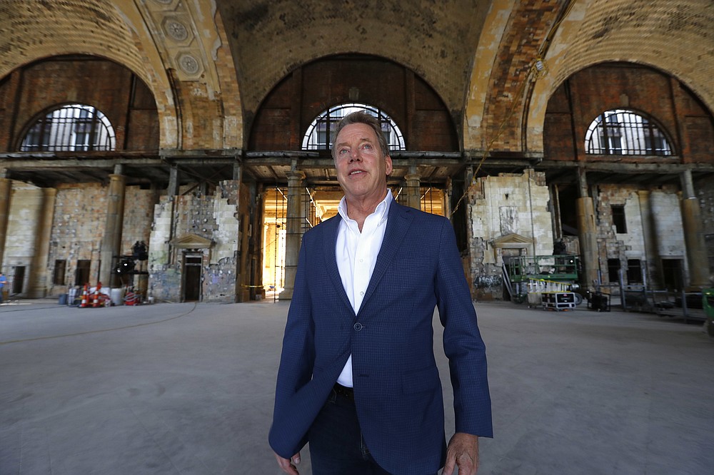 FILE - In this June 14, 2018, file photo, Bill Ford Jr., Ford Motor Company Executive Chairman and Chairman of the Board, poses in the Michigan Central Station in Detroit. Ford Motor Co. is expanding its footprint in Detroit's Corktown neighborhood by adding onto plans that began with its purchase and renovation of the massive and once-derelict station. The Dearborn, Michigan-based automaker also plans to turn a vacant book warehouse into the industrial center for its 30-acre Michigan Central mobility innovation district. Details were released Tuesday, Nov. 17, 2020, and are part of Ford's $740 million project to create an innovation hub to help shape the way people and goods will move around in the future. (AP Photo/Paul Sancya File)