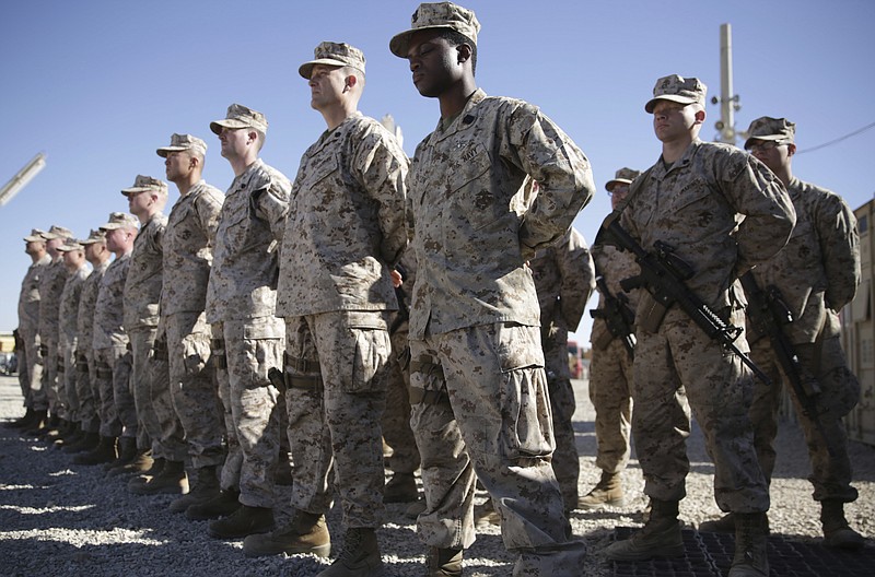 In this Jan. 15, 2018, file photo, U.S. Marines watch during the change of command ceremony at Task Force Southwest military field in Shorab military camp of Helmand province, Afghanistan. An accelerated U.S. troop withdrawal from Afghanistan, announced by Washington, Tuesday, has rattled both allies and adversaries and raised fears of worsening violence and regional chaos, which some say could embolden the Islamic State affiliate in the country to try to regroup in a lawless Afghanistan. - AP Photo/Massoud Hossaini story.lead_photo.caption