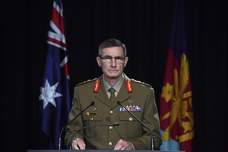 Chief of the Australian Defence Force Gen. Angus Campbell delivers the findings from the Inspector-General of the Australian Defence Force Afghanistan Inquiry, in Canberra, Thursday, Nov. 19, 2020. A shocking report into war crimes by elite Australian troops has found evidence that 25 soldiers unlawfully killed 39 Afghan prisoners, farmers and civilians. (Mick Tsikas/Pool Photo via AP)