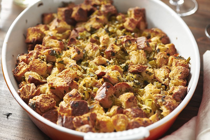 This August 2020 photo shows a recipe for traditional Thanksgiving stuffing in New York. The recipe can be cut in half and baked in a smaller pan for less time for a smaller group. - Katie Workman via AP story.lead_photo.caption