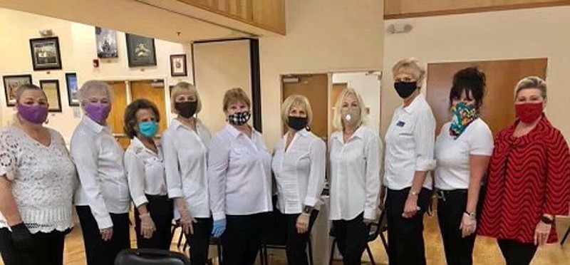From left are Holiday Tea and Fashion Show servers Jackie Brown, Diann Northern, Margie Yates, Sherry Miller, Pam Gruber, Jerri Roper, Carole Harper, Nancy Pequignot, Kay Fischer and Emblem Club President Ginger Yates. - Submitted photo story.lead_photo.caption