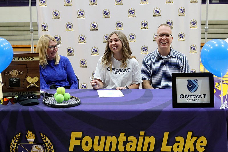 Fountain Lake tennis player Jordan Lancaster, center, smiles Thursday after signing a letter of intent to play tennis at Covenant College next year. She was joined at the signing ceremony in Irvin J. Bass Gymnasium by her mother Melissa and her father Jason. - Photo by Richard Rasmussen of The Sentinel-Record