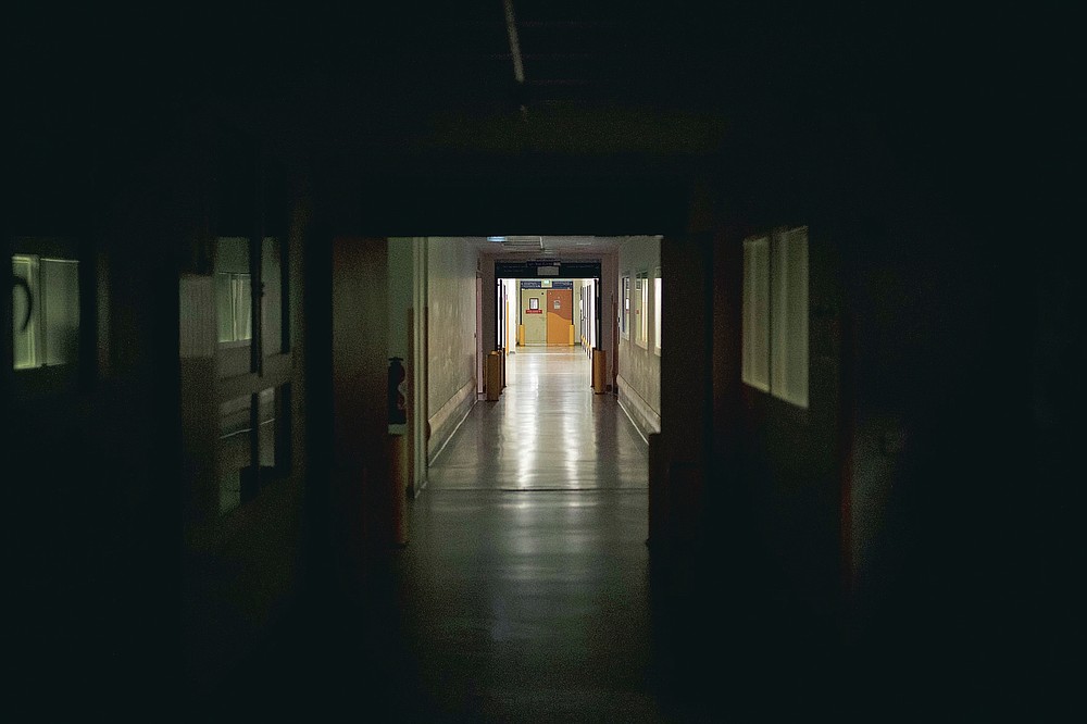 An empty corridor leading to the the COVID-19 ICU at the La Timone hospital is pictured at night in Marseille, southern France, Thursday, Nov. 12, 2020. France is more than two weeks into its second coronavirus lockdown, and intensive care wards have been over 95% capacity for more than 10 days now. Marseille has been submerged with coronavirus cases since September. (AP Photo/Daniel Cole)