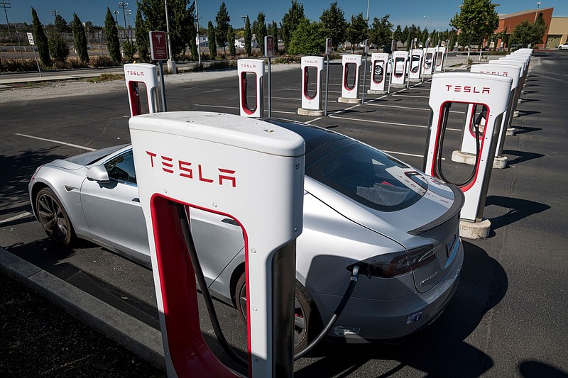 A Tesla vehicle charges at a Tesla Supercharger station in Petaluma, Calif., on Sept. 24, 2020. MUST CREDIT: Bloomberg photo by David Paul Morris