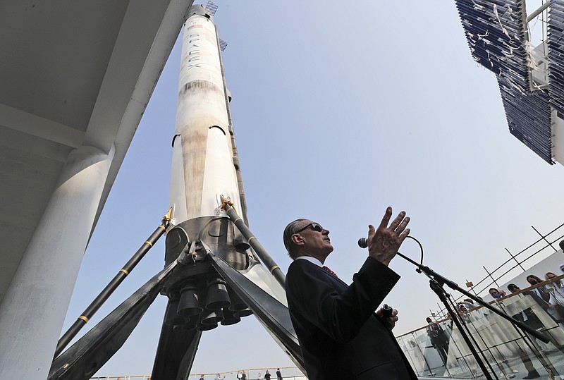 U.S. Ambassador John Rakolta talks in front of replica of the SpaceX Falcon 9, during the U.S.A Pavilion handover ceremony at the Dubai Expo 2020, United Arab Emirates, Wednesday, Nov. 18, 2020. The U.S. showed off a literally star-studded pavilion Wednesday for Dubai's upcoming Expo 2020, complete with a replica SpaceX rocket body beside it. (AP Photo/Kamran Jebreili)