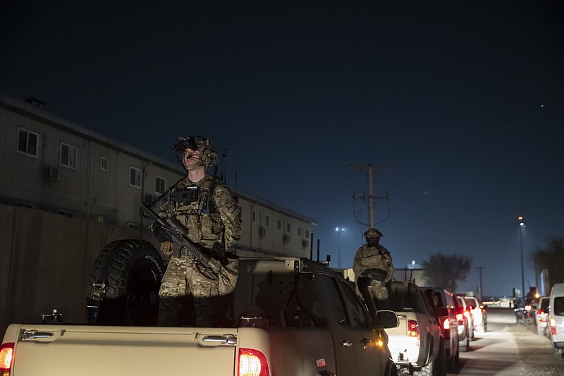 FILE - In this Nov. 28, 2019, file photo armed soldiers stand guard in the motorcade for President Donald Trump speaks during a surprise Thanksgiving Day visit to the troops at Bagram Air Field, Afghanistan. Although the Islamic State extremist group is battered and scattered, it cannot be fully defeated until the world finds a way to reconcile and resettle the thousands of people displaced by years of war in Iraq and Syria, the general overseeing American military operations in the Mideast said Thursday, Nov. 19, 2020. (AP Photo/Alex Brandon, File) story.lead_photo.caption