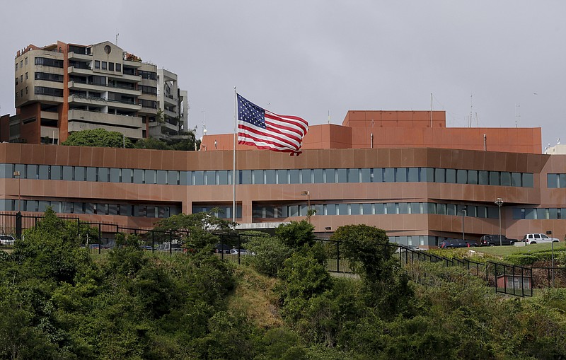 FILE - In this Jan. 24, 2019 file photo, the U.S flag flies outside the U.S. embassy in Caracas, Venezuela. U.S. charge d'affairs for Venezuela James Story and his team of fellow diplomats lowered the flag at the U.S. Embassy in March 2019, just a couple months after President Donald Trump recognized opposition leader Juan Guaido as Venezuela's legitimate leader. (AP Photo/Fernando Llano, File) story.lead_photo.caption