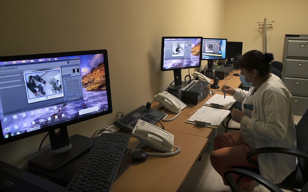 A healthcare worker monitors patients infected with COVID-19 via monitors at the Ajusco Medio General Hospital in Mexico City, Thursday, Nov. 19, 2020. (AP Photo/Marco Ugarte)