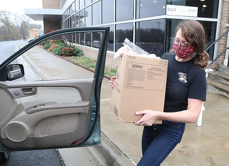 Lake Hamilton School Child Nutrition Director Deidra Stron places a box of breakfasts and lunches into a waiting car on Friday. - Photo by Richard Rasmussen of The Sentinel-Record story.lead_photo.caption