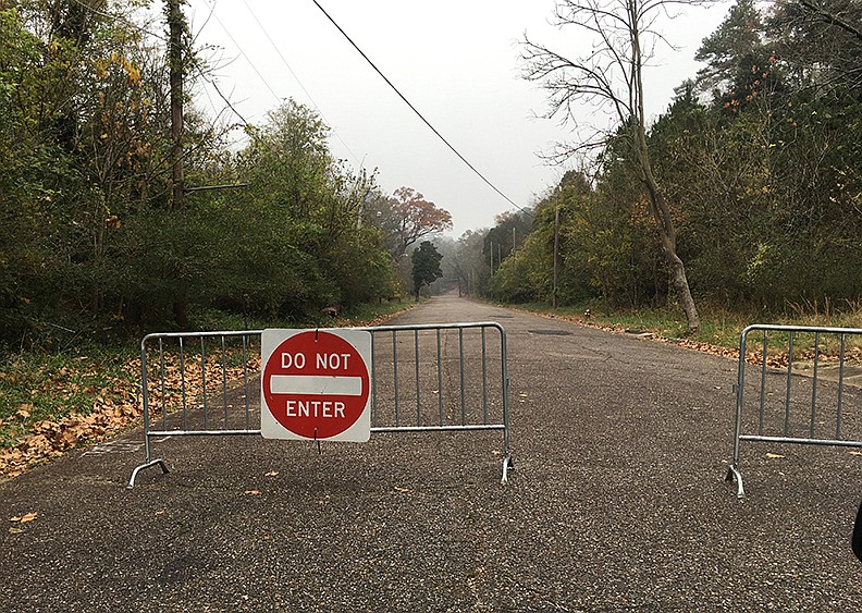 Pullman Trail, which remained closed Friday after a fire in a truck stolen from the Garland County landfill spread to the forest Thursday morning, is expected to reopen today, according to Traci Berry, Northwoods Trails coordinator. The Pullman Trailhead parking area at the end of Pullman Avenue was also closed due to the fire. Barricades on Friday blocked access to the area. - Photo by Richard Rasmussen of The Sentinel-Record story.lead_photo.caption