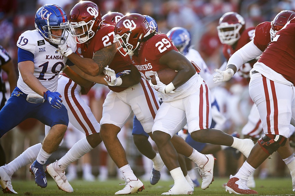 Oklahoma running back Rhamondre Stevenson (29) carries the ball during an NCAA college football game against Kansas in Norman, Okla., Saturday, Nov. 7, 2020. (Ian Maule/Tulsa World via AP)