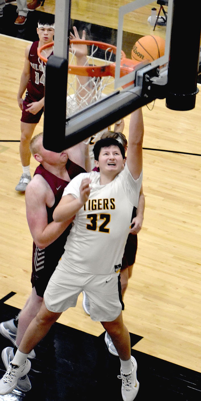 MARK HUMPHREY  ENTERPRISE-LEADER/Prairie Grove's Ethan Gross powers in a layup in the first quarter against Siloam Springs. The Panthers beat the Tigers 79-27 on Thursday.