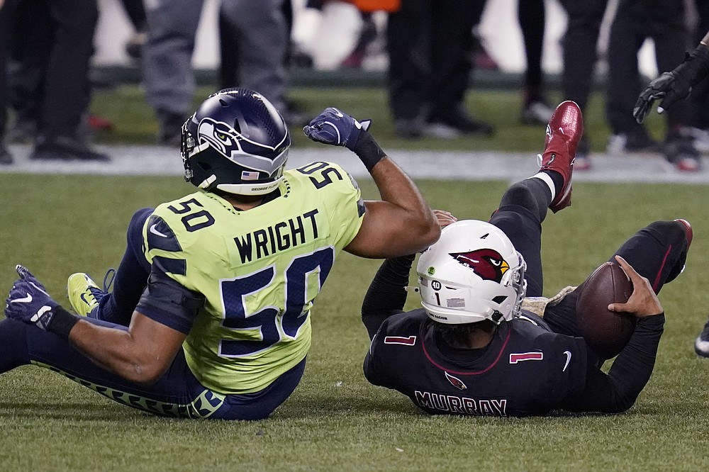 Arizona Cardinals quarterback Kyler Murray (1) is tackled by Seattle Seahawks outside linebacker K.J. Wright (50) during the first half of an NFL football game, Thursday, Nov. 19, 2020, in Seattle. (AP Photo/Elaine Thompson)