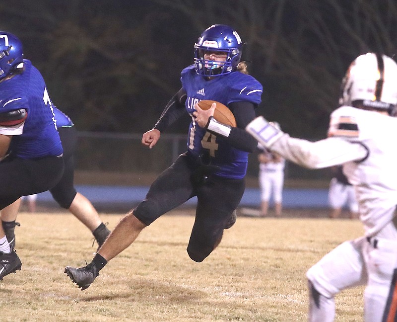 Jessieville junior quarterback Carson Hair (14) heads upfield during the first half of Friday's first-round Class 3A playoff game against Harrisburg at Don Phillips Field. - Photo by Richard Rasmussen of The Sentinel-Record story.lead_photo.caption