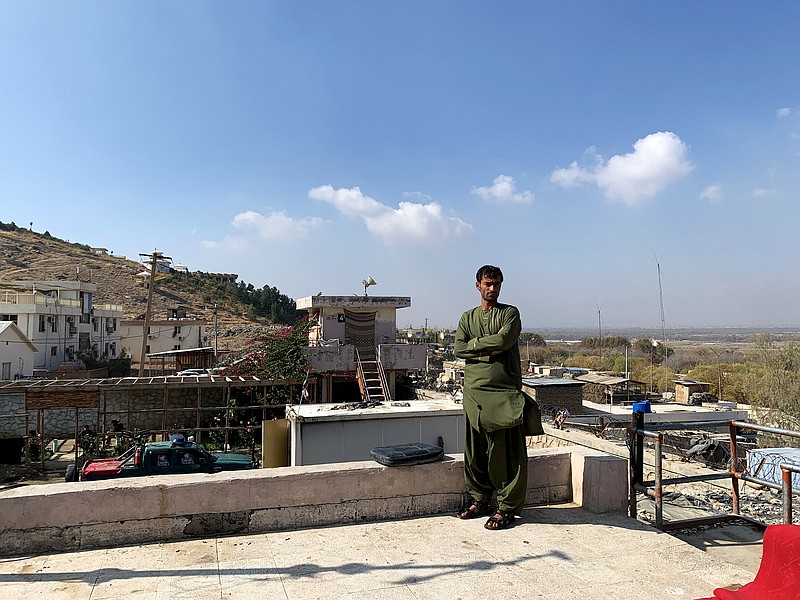 Javid Ahmed, a member of Afghanistan's national police, stands atop an outpost on the edge of Kandahar city overlooking Arghandab district. The district had been in government control for over a decade before it was overrun by the Taliban earlier this month as the militants launched a series of offensives across southern Afghanistan. MUST CREDIT: Washington Post photo by Susannah George