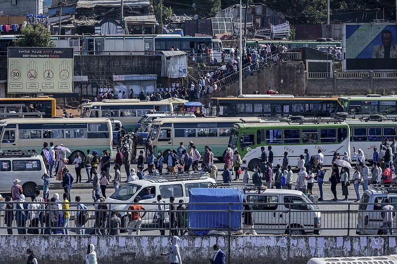 Passengers queue to get on buses in the capital Addis Ababa, Ethiopia Friday, Nov. 6, 2020. Ethiopia's prime minister says airstrikes have been carried out against the forces of the country's Tigray region, asserting that the strikes in multiple locations "completely destroyed rockets and other heavy weapons." (AP Photo/Mulugeta Ayene) story.lead_photo.caption