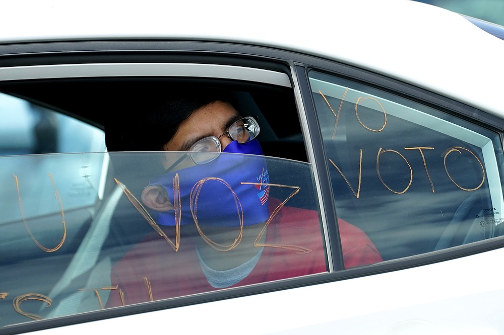 FILE - In this Aug. 13, 2020, file photo a man looks out of a car window as he takes part in a car rally at the Capitol in Phoenix. “We are at a point where there was no pathway to victory” for Democrats without support from voters of color, said Alejandra Gomez, co-executive director of the political group Living United for Change in Arizona. “Our terrain has forever changed in this country in terms of the electoral map. (AP Photo/Matt York, File)