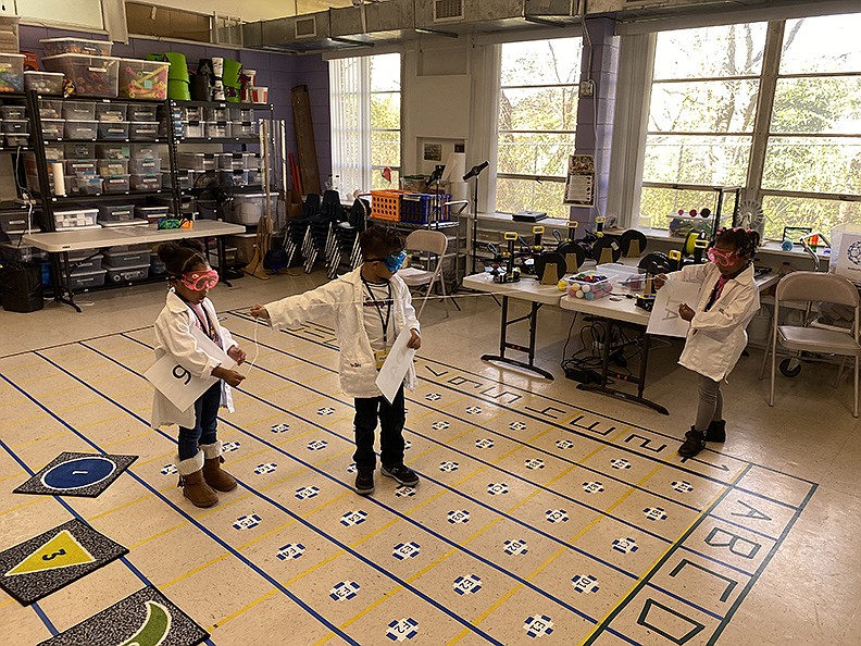 From left, pre-K students Aalayah Jordon, Marshon Williams and Liy’ric Foote participate in STEAM activities. - Photo by John Anderson of The Sentinel-Record