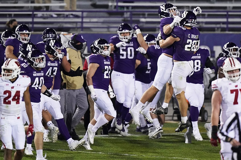 Northwestern players celebrate after they defeated Wisconsin 17-7 in an NCAA college football game in Evanston, Ill., Saturday, Nov. 21, 2020. (AP Photo/Nam Y. Huh)