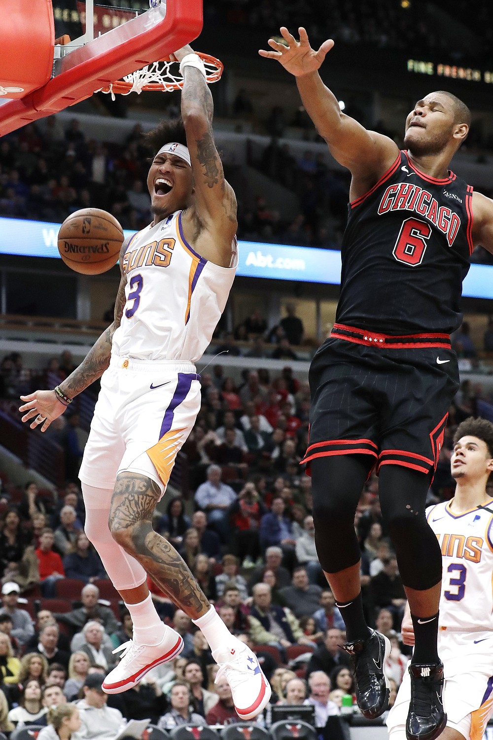 Phoenix Suns forward Kelly Oubre Jr., left, reacts as he dunks against Chicago Bulls forward/center Cristiano Felicio during the second half of an NBA basketball game in Chicago, Saturday, Feb. 22, 2020. (AP Photo/Nam Y. Huh)