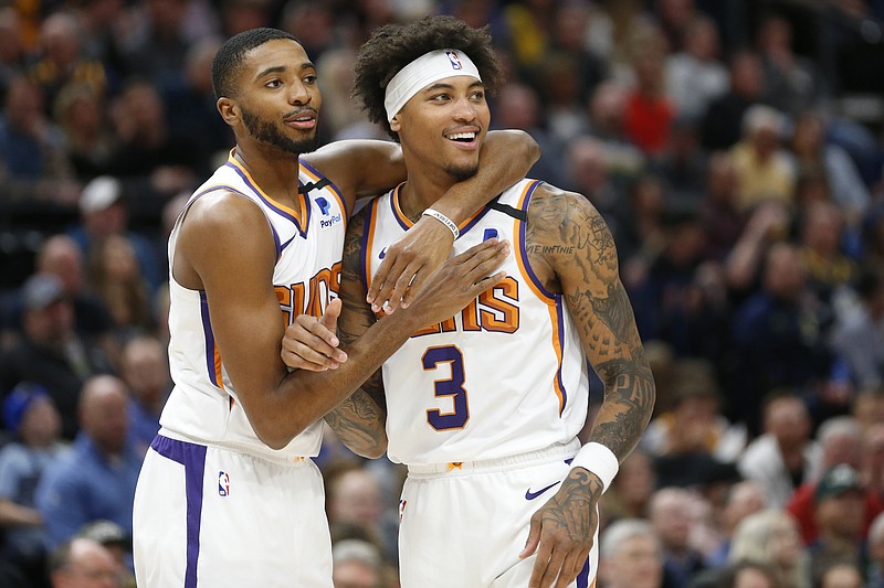 Phoenix Suns forward Mikal Bridges, left, and forward Kelly Oubre Jr. (3) react to a foul called on Oubre in the first half during an NBA basketball game against the Utah Jazz, Monday, Feb. 24, 2020, in Salt Lake City. (AP Photo/Rick Bowmer)