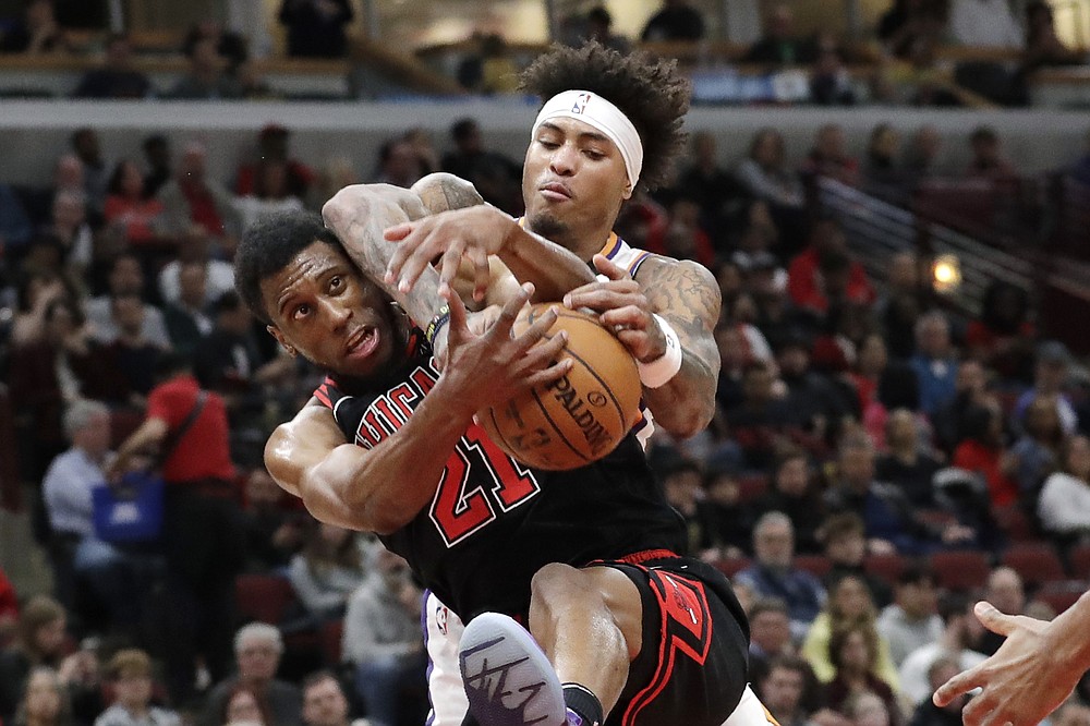 Chicago Bulls forward Thaddeus Young, left, and Phoenix Suns forward Kelly Oubre Jr., battle for a rebound during the second half of an NBA basketball game in Chicago, Saturday, Feb. 22, 2020. (AP Photo/Nam Y. Huh)