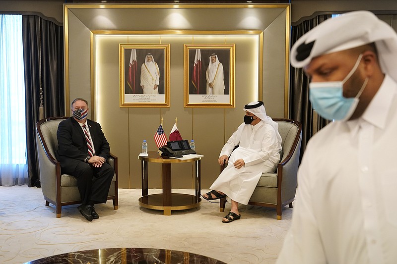U.S. Secretary of State Mike Pompeo, left, meets with Qatar's Deputy Prime Minister and Minister of Foreign Affairs Mohammed bin Abdulrahman Al Thani, Saturday, Nov. 21, 2020, in Doha, Qatar. (AP Photo/Patrick Semansky, Pool)