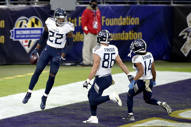 Tennessee Titans running back Derrick Henry (22) celebrates his game-winning touchdown with tight end Anthony Firkser (86) and wide receiver Kalif Raymond (14) during overtime of an NFL football game against the Baltimore Ravens, Sunday, Nov. 22, 2020, in Baltimore. The Titans won 30-24 in overtime. (AP Photo/Gail Burton)