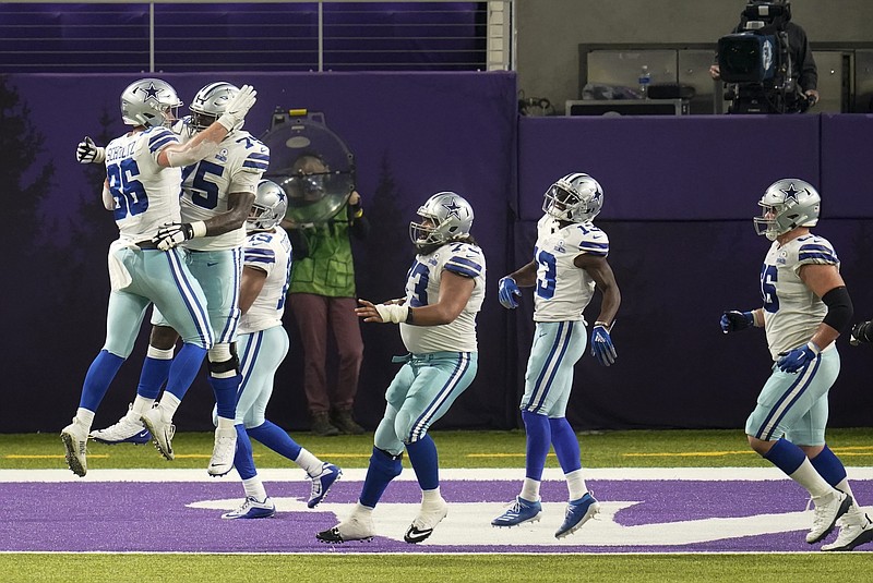 Dallas Cowboys tight end Dalton Schultz, left, celebrates with teammates after catching a 2-yard touchdown pass during the second half of an NFL football game against the Minnesota Vikings, Sunday, Nov. 22, 2020, in Minneapolis. (AP Photo/Jim Mone)