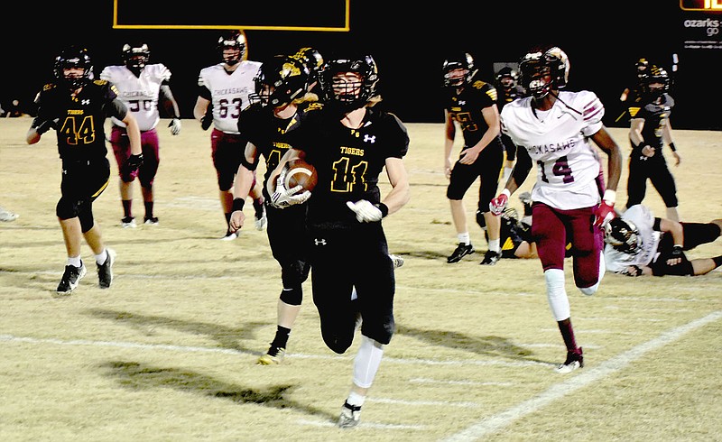 MARK HUMPHREY  ENTERPRISE-LEADER/Icing on the cake. Prairie Grove junior Paytin Higgins returned an interception 85 yards for a touchdown to cap the scoring in the Tigers' 59-34 Class 4A playoff victory over Blytheville Friday. Higgins also kicked 7-of-7 extra-points. He was given a break after the long runback and Cade Walker kicked that P.A.T.
