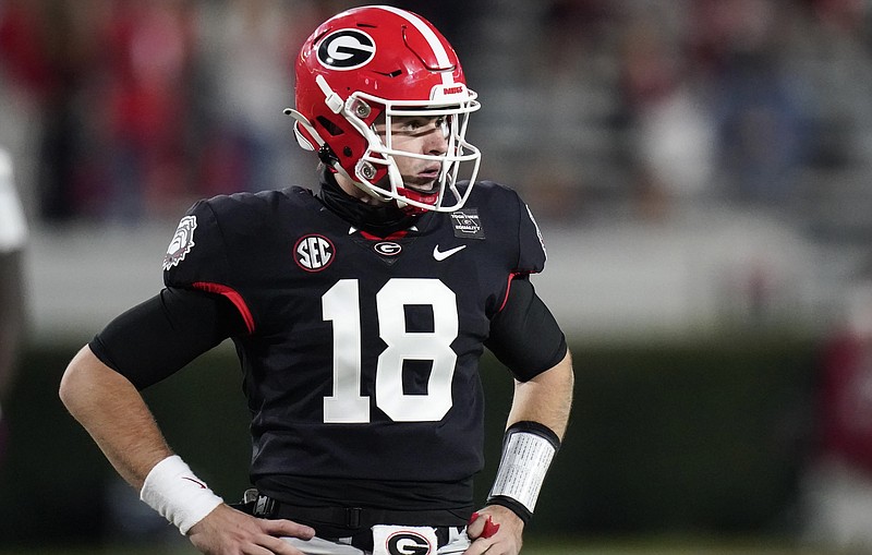 Georgia quarterback JT Daniels looks for a play call from the sideline during the first half of the team's NCAA college football game against Mississippi State, Saturday, Nov. 21, 2020, in Athens, Ga. (AP Photo/Brynn Anderson)