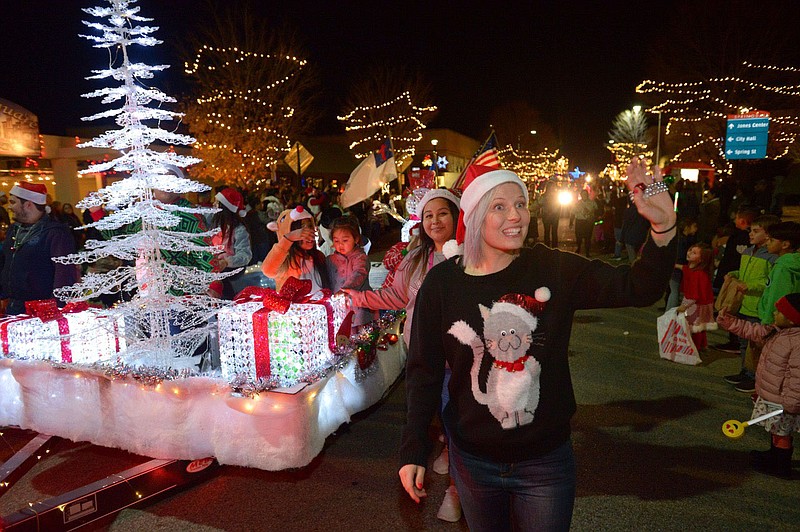 NWA Democrat-Gazette/ANDY SHUPE
Kirstie Montgomery waves to the crowd Saturday, Nov. 24, 2018, while walking with the Springdale Sam's Club float during the Christmas on the Creek in downtown Springdale. The event featured live music, a Christmas tree lighting and ended with the 22nd annual Rodeo of the Ozarks Christmas Parade.
