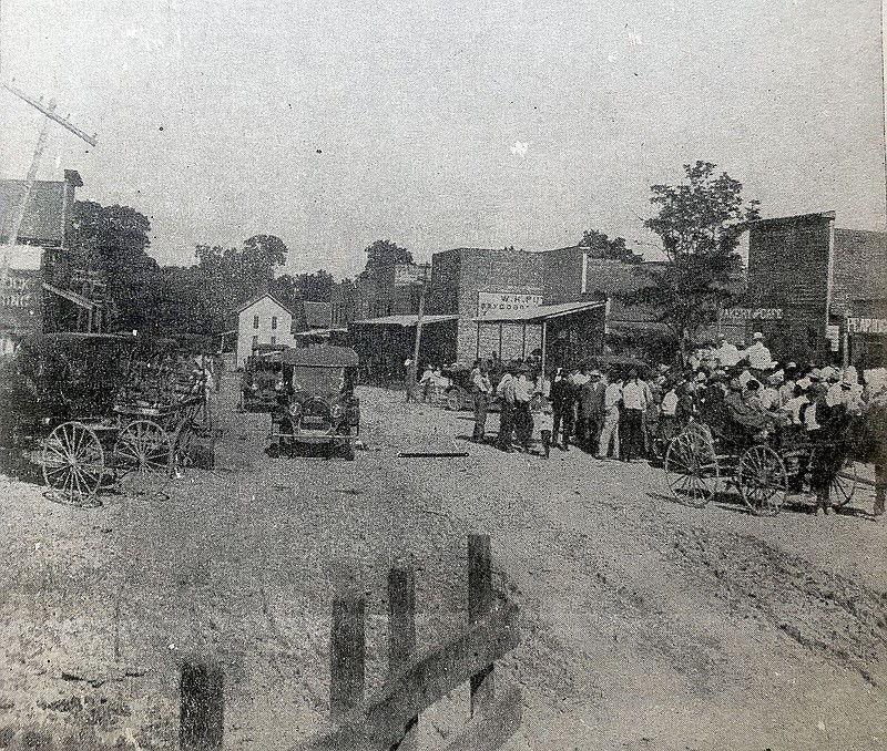 Pea Ridge 1920 — the photograph appears to have been taken from across the street from the former location of the Post Office leaking eastward. The corner building bearing the sign W.H. Putman Dry Good appears to be the building vacated in the 1970s by Pea Ridge Furniture.