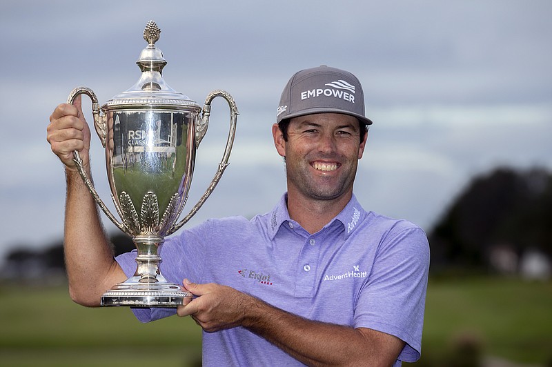 Robert Streb holds the trophy after winning a second hole playoff Sunday against Kevin Kisner at the RSM Classic in St. Simons Island, Ga. - Photo by Stephen B. Morton of The Associated Press