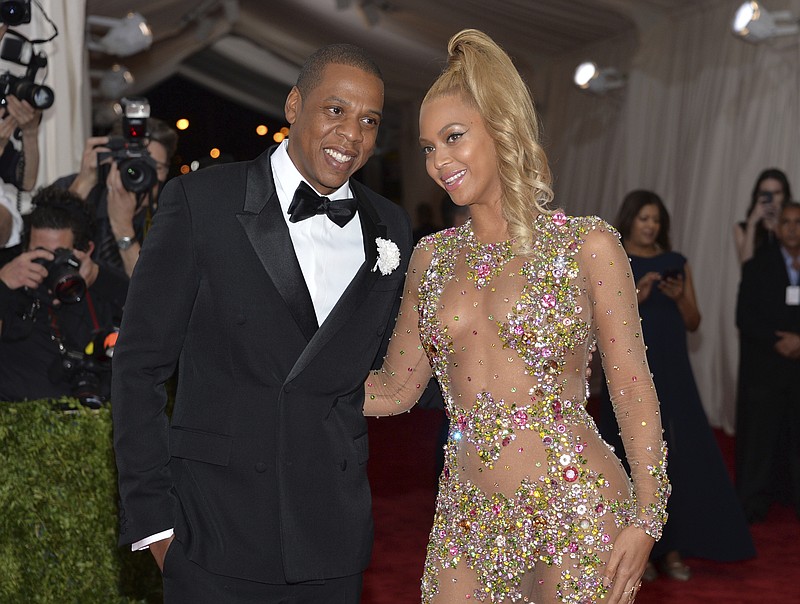 FILE - In this May 4, 2015, file photo, Jay Z, left, and Beyonce arrive at The Metropolitan Museum of Art's Costume Institute benefit gala celebrating "China: Through the Looking Glass" in New York. Beyonce was nominated for nine Grammy Awards on Tuesday. She is tied with  Paul McCartney for the second-most nominated act in the history of the awards show with 79 nominations. Her husband Jay-Z and Quincy Jones, who have both earned 80 nominations each, are tied for first place. (Photo by Evan Agostini/Invision/AP, File)