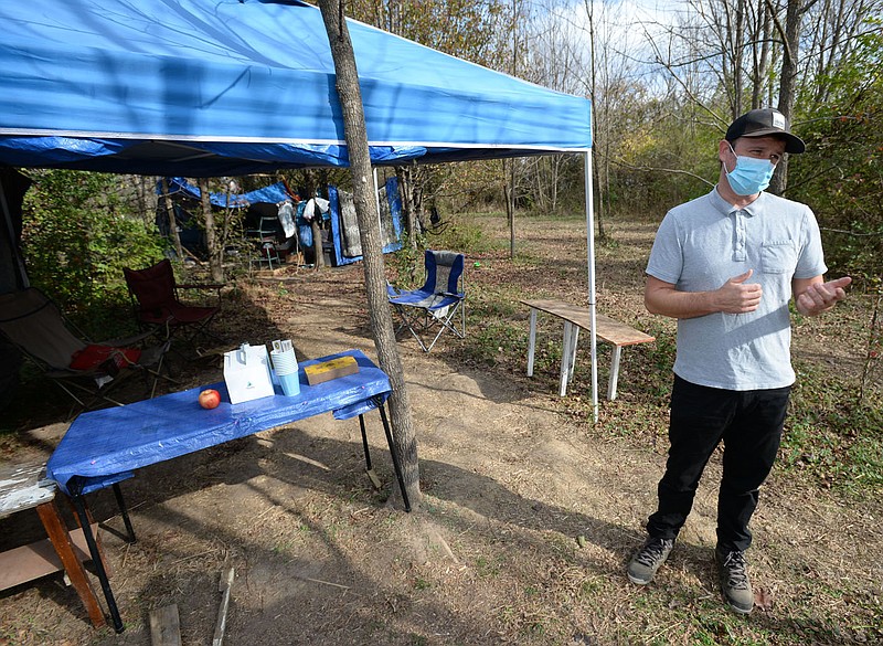 Solomon Burchfield, director of New Beginnings Bridge Housing, leads a tour Friday, Nov. 20, 2020, of Safe Camp near the American Legion Post in Fayetteville. The camp was established using federal Coronavirus Aid, Relief and Economic Security Act money to help prevent the spread of covid-19 among people experiencing homelessness. Visit nwaonline.com/201126Daily/ for today's photo gallery.
(NWA Democrat-Gazette/Andy Shupe) story.lead_photo.caption