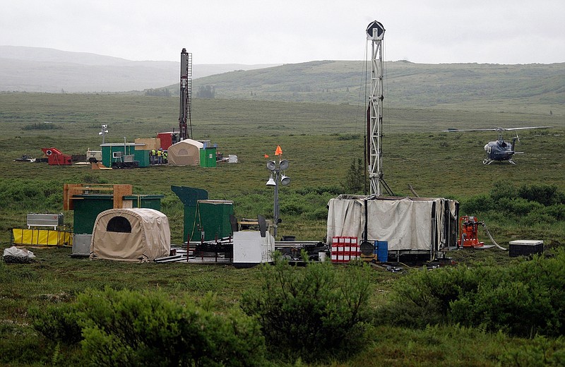 FILE - In this July 13, 2007, file photo, workers with the Pebble Mine project test drill in the Bristol Bay region of Alaska, near the village of Iliamma. A proposed gold and copper mine at the headwaters of the world's largest sockeye salmon fishery in Alaska would cause "unavoidable adverse impacts," the U.S. Army Corps of Engineers said in a letter to the developer released Monday, Aug. 24, 2020. The corps is asking the backers of Pebble Mine to come up with a mitigation plan within 90 days for nearly 3,000 acres of land and nearly 200 miles of streams it says could be affected if the controversial mine moves forward.  (AP Photo/Al Grillo, File)