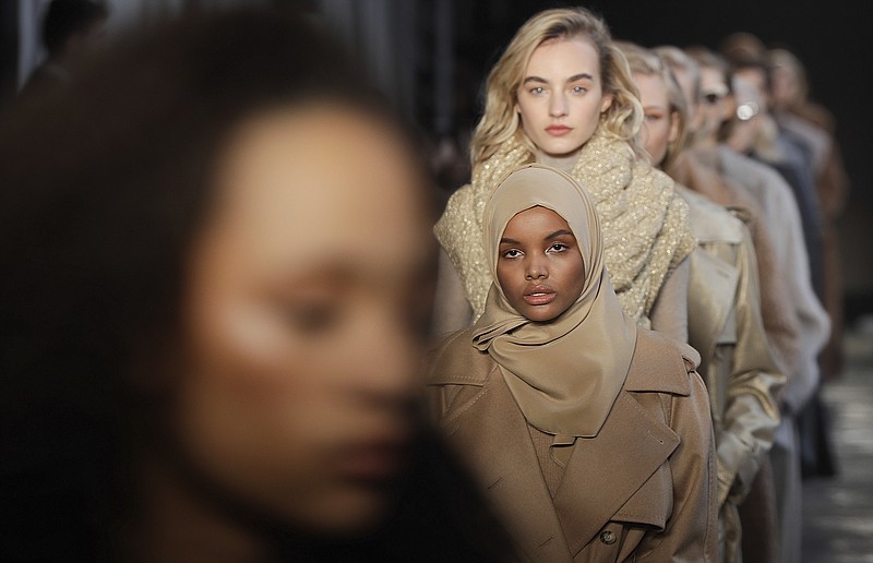 FILE - In this Feb. 23, 2017 file photo, Somali-American model Halima Aden wears a creation part of the Max Mara women's Fall-Winter 2017-18 collection, that was presented in Milan, Italy. Somali-American model Halima Aden has announced that she is taking a step back from the fashion industry, saying that the pandemic slowdown has given her time to see instances when her desire to maintain a hijab was not properly respected. (AP Photo/Luca Bruno).