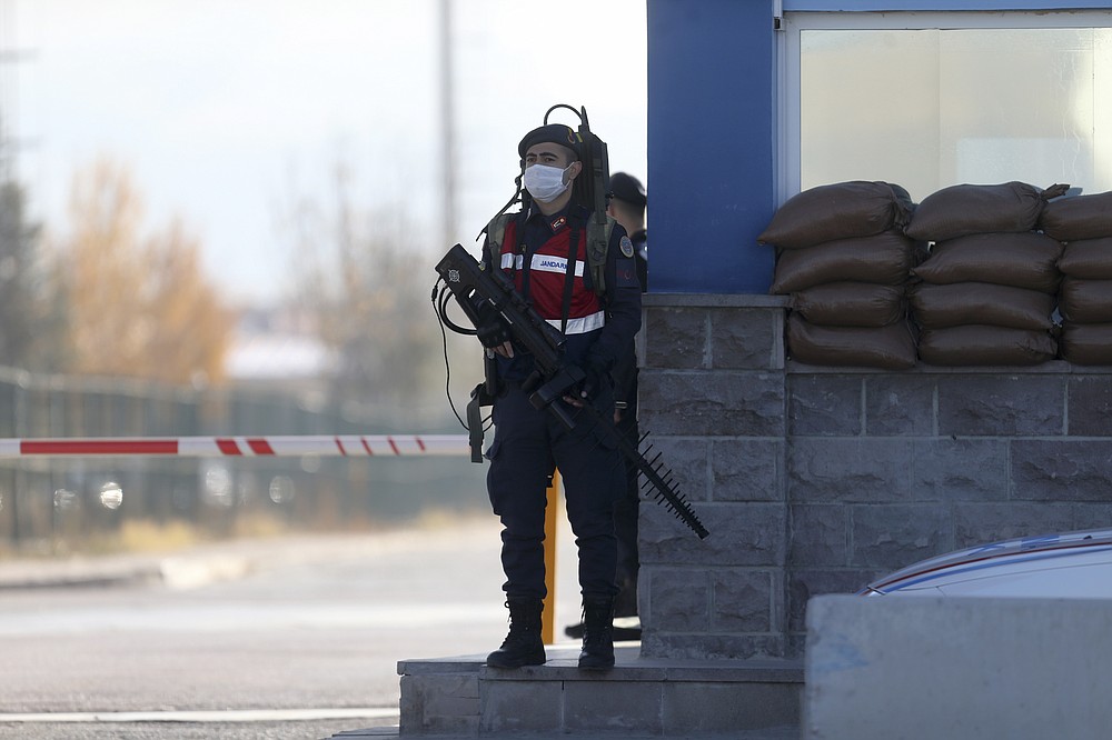 A soldier stands at the entrance of a courthouse before the trial of 475 defendants, including generals and fighter jet pilots, in Sincan, Ankara, Turkey, Thursday, Nov. 26, 2020. A Turkish court sentenced several military and civilian personnel at an air base to life prison sentences on Thursday, proclaiming them guilty of involvement in a failed coup attempt in 2016, the state-run news agency reported. (AP Photo)