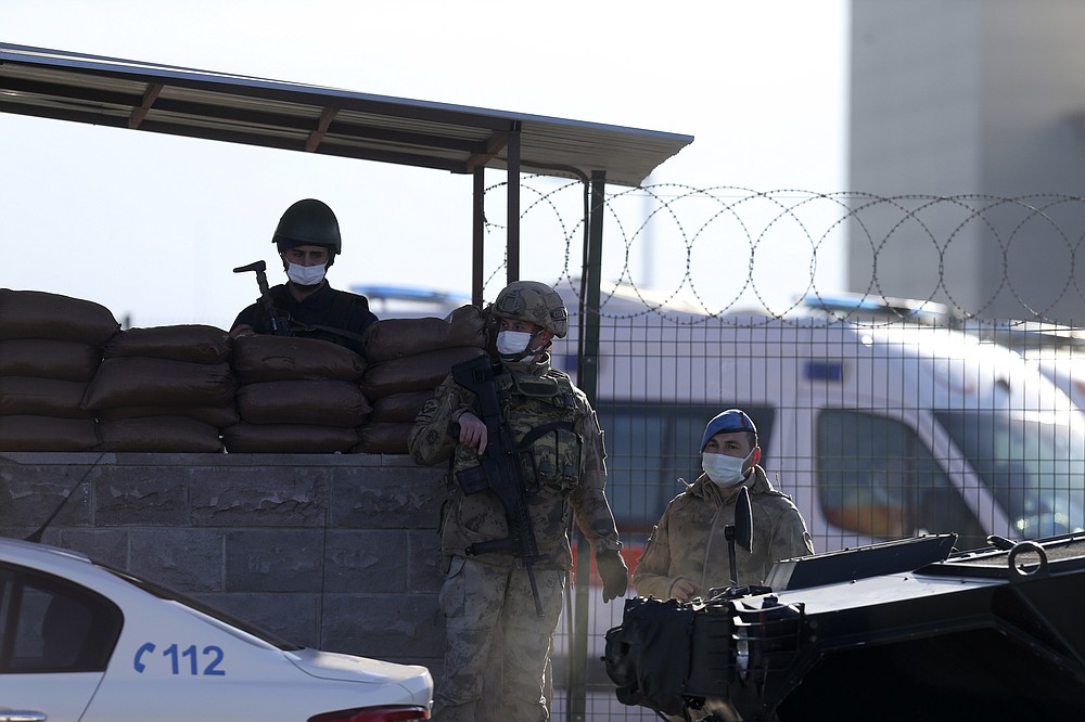 Soldiers stand at the entrance of a courthouse before the trial of 475 defendants, including generals and fighter jet pilots, in Sincan, Ankara, Turkey, Thursday, Nov. 26, 2020. A Turkish court sentenced several military and civilian personnel at an air base to life prison sentences on Thursday, proclaiming them guilty of involvement in a failed coup attempt in 2016, the state-run news agency reported. (AP Photo)