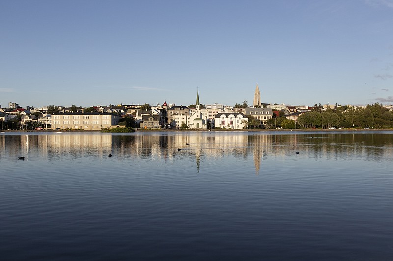 Buildings stand on the edge of Lake Tjornin in Reykjavik, Iceland, on July 20, 2020. MUST CREDIT: Bloomberg photo by Sigga Ella