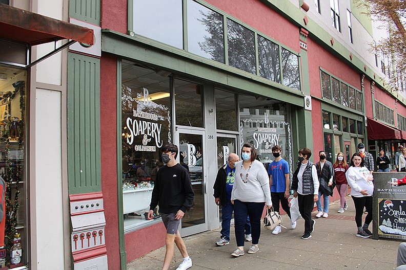 Black Friday shoppers walk past the Bathhouse Soapery on Friday. - Photo by Tanner Newton of The Sentinel-Record