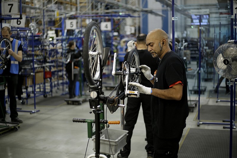 Brompton folding bicycles are assembled by hand at the Brompton factory in west London, Tuesday. The team at Brompton Bicycles company thought they were prepared for Britain's Brexit split with Europe, but they face uncertainty about supplies and unexpected new competition from China, all amid a global COVID pandemic. - AP Photo/Matt Dunham