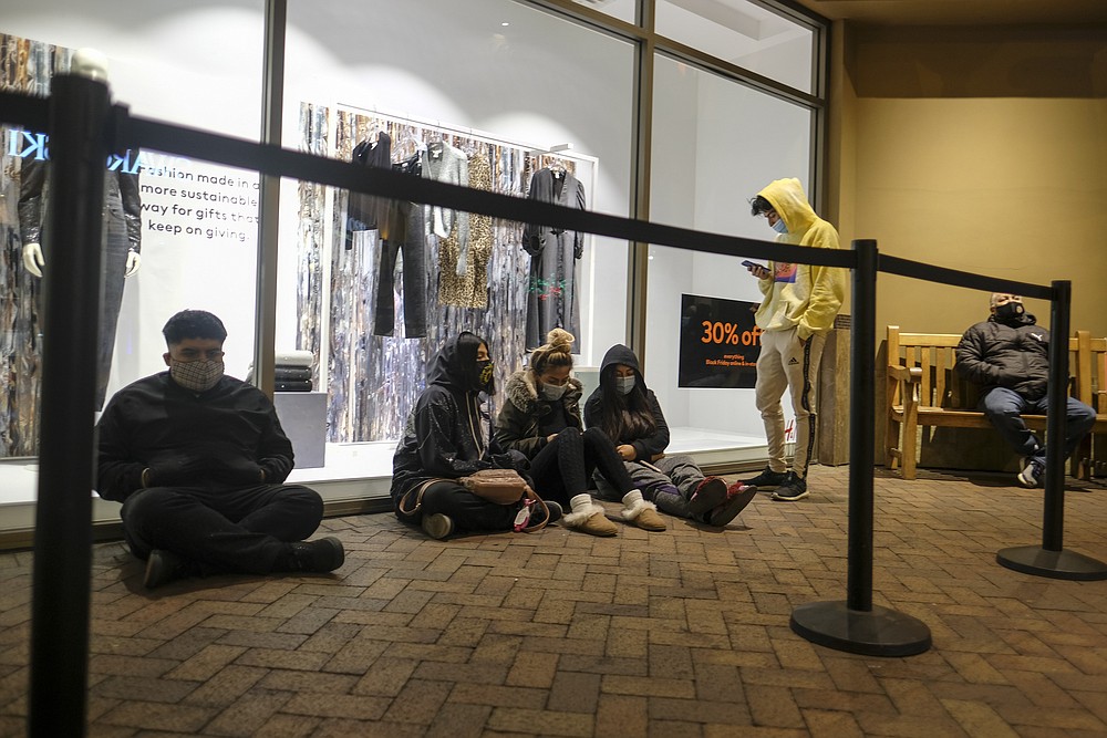Black Friday shoppers wait in line to enter an shore that opened at 6am at the Citadel Outlets in Commerce, Calif., Friday, Nov. 27, 2020. (AP Photo/Ringo H.W. Chiu)