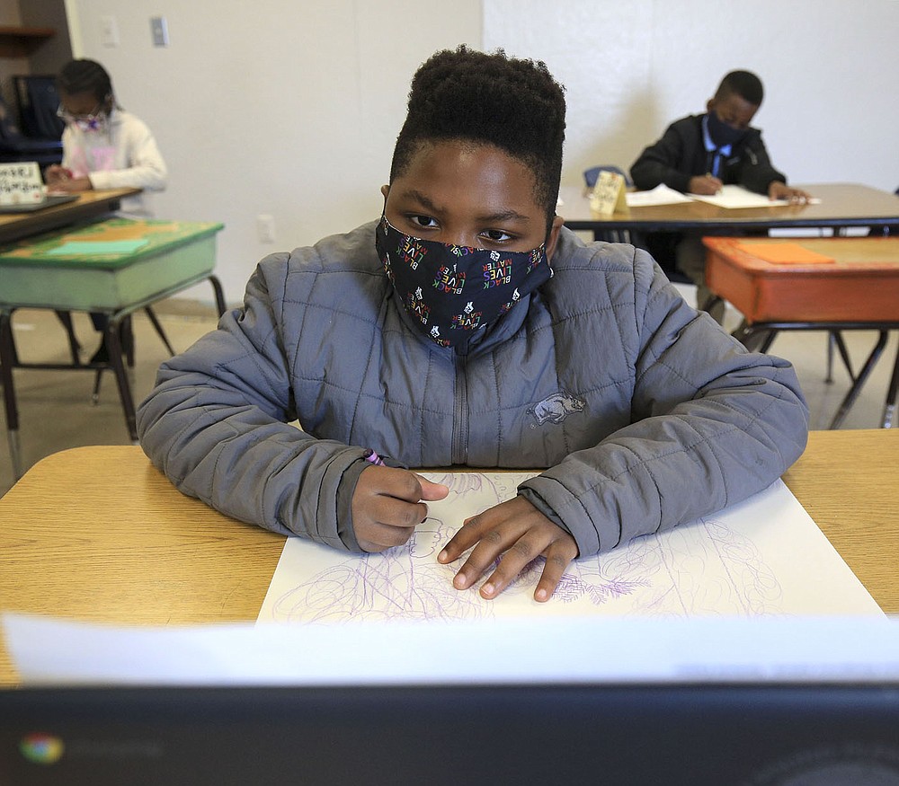 Jeremy Williams, 9, works Nov. 18 on an art project during Stephanie Crowell's fourth-grade art class at Carver Magnet Elementary School in Little Rock. Check out nwaonline.com/201129Daily/ for today's photo gallery.
(Arkansas Democrat-Gazette/Staton Breidenthal)