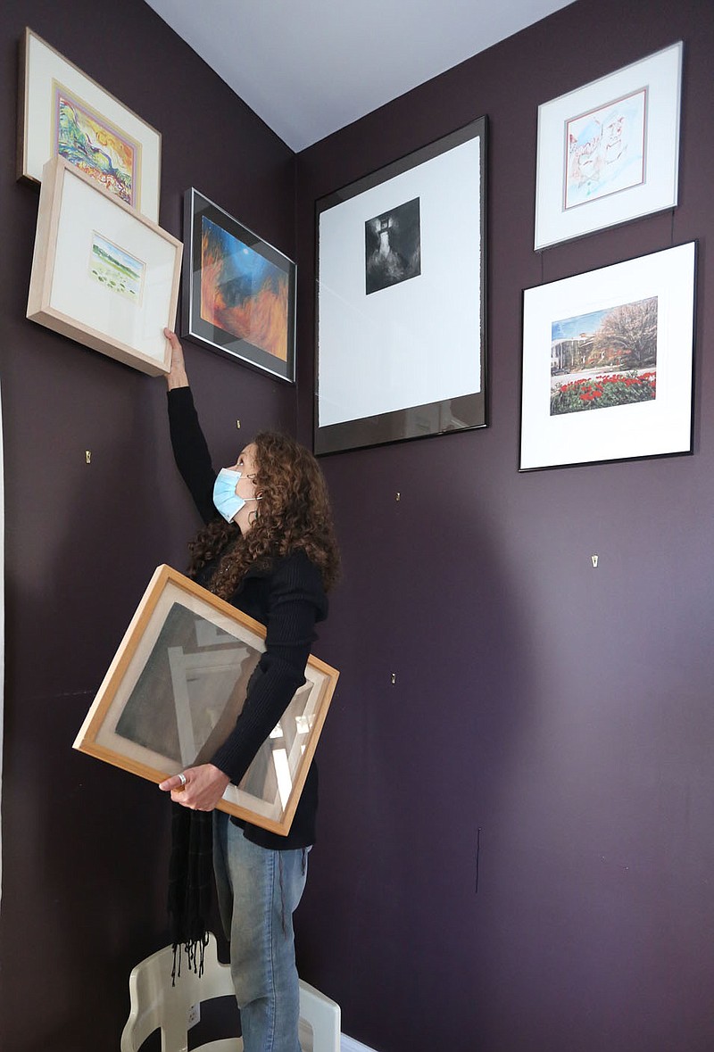 Cheri Bohn, gallery assistant at Art Ventures, removes art work Monday, November 23, 2020, for storage at 20 S. Hill Avenue in Fayetteville. The art work will be replaced with artists representing Art Ventures. Creative Arkansas Community Hub and Exchange announced the launch of its inaugural ARt Connect professional development program and its cohort of local arts and culture organizations. CACHE developed the two-year organizational development program in partnership with Mid-America Arts Alliance. Check out nwaonline.com/201126Daily/ and nwadg.com/photos for a photo gallery.(NWA Democrat-Gazette/David Gottschalk)